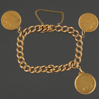 Pulsera de eslabones en oro amarillo de 18 kt con tres monedas a modo de colgante.