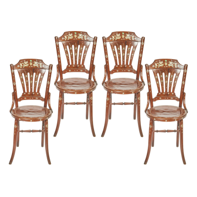 Juego de cuatro sillas orientales en madera frutal tallada con decoración incrustada en nácar de motivos florales y geométricos, s.XX.
