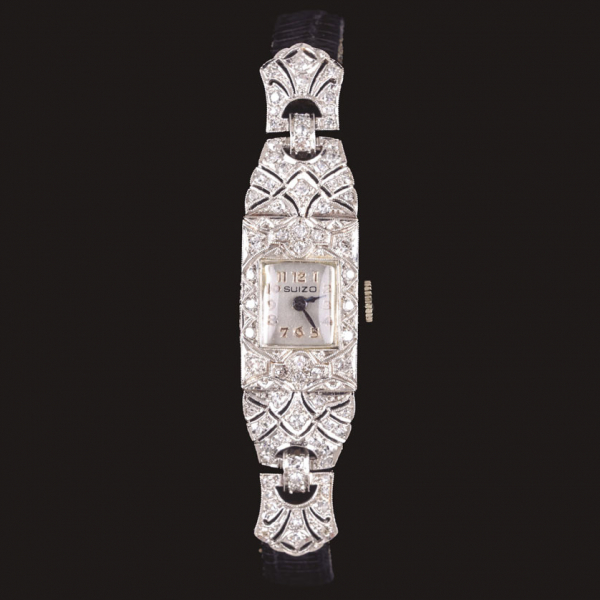 Reloj de pulsera para señora marca SUIZO, realizado en platino con caja adornada por diamantes.