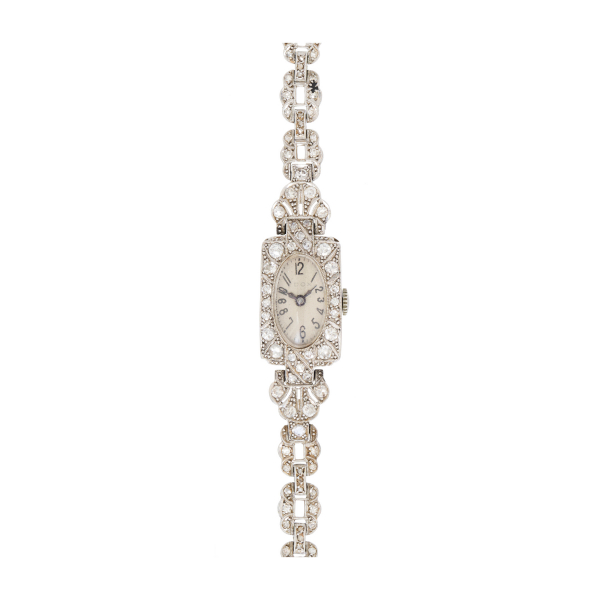 Reloj Art Deco «Dox»de pulsera para señora, c.1930. En platino. Armis y bisel cuajados de diamantes tallas brillante antigua y 8/8. 