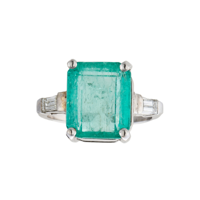 Sortija en oro blanco con esmeralda talla octogonal custodiada por diamantes talla baguett engastados en garras.