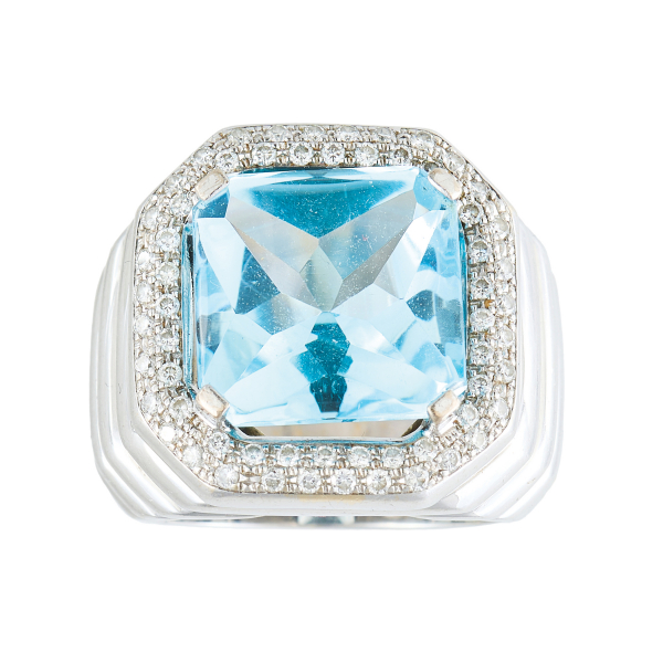 Sortija diseño sello en oro blanco con brazos gallonados y topacio azul talla octogonal de 12 x 12 mm. orlado por pavé de diamantes talla brillante.
