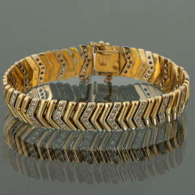 Pulsera articulada en oro amarillo y oro blanco de 18 kt con brillantes.