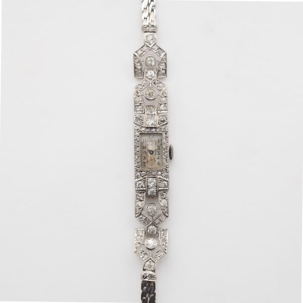CYMA. Reloj Art Dec&oacute; de pulsera para se&ntilde;ora en platino con armis de doble trenza plana (realizado posteriormente) en oro blanco.