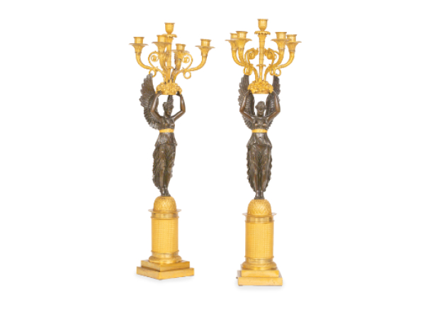 Pareja de candelabros imperio de bronce dorado y pavonado con cari&aacute;tides sustentando cinco brazos de luz. Trabajo franc&eacute;s, (1804-1814).