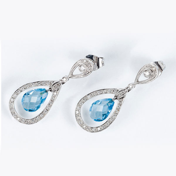 Pendientes largos en oro blanco 18 K., con motivos colgantes en perilla calada con blancos diamantitos, talla brillante