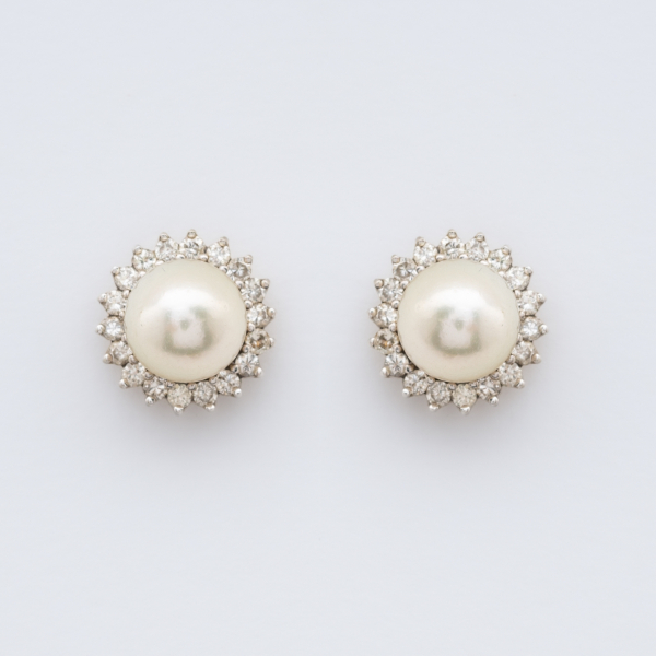 Pendientes roset&oacute;n en oro blanco con perla cultivada de 8,5 mm. orlada por diamantes talla brillante.