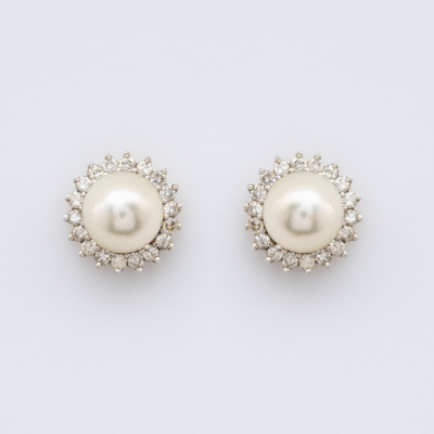 Pendientes roset&oacute;n en oro blanco con perla cultivada de 8,5 mm. orlada por diamantes talla brillante.