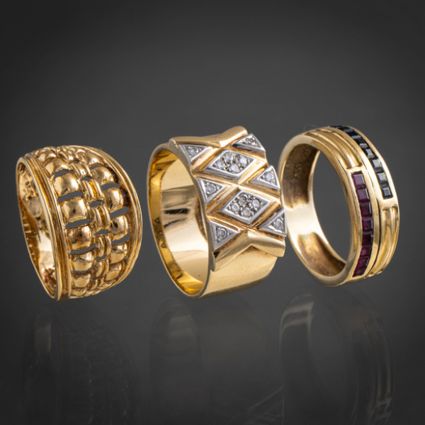 Conjunto de tres anillos en oro amarillo de 18 kt con brillantes, zafiros y rubíes calibrados.