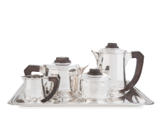 Jean Elysée Puiforcat (1897-1945)*.  Juego de café y té Art-Decó de plata con asas y remates de madera de palo de rosa. Ley 950.  