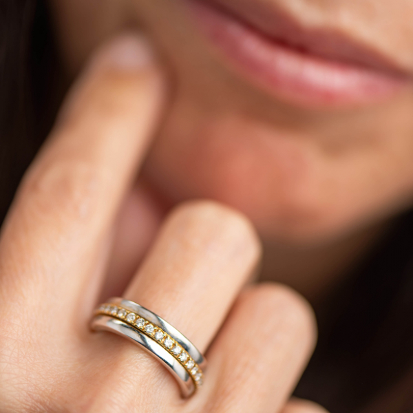 Anillo giratorio en oro blanco y oro amarillo de 18kt orlado de brillantes.