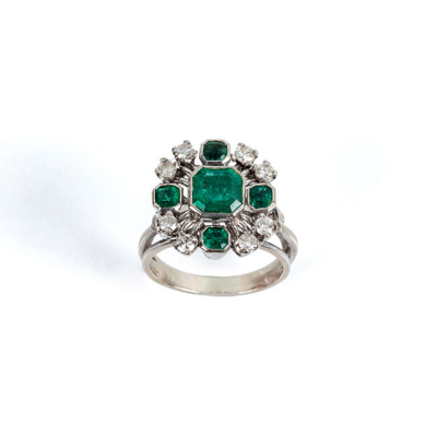 Sortija vintage en sólida montura de oro blanco 18 K con una bella esmeralda natural, orlada de limpios y blancos diamantes 