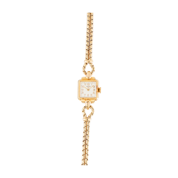Reloj Longines de pulsera para señora, c.1930. En oro. Esfera en color marfil con numeración arábiga.