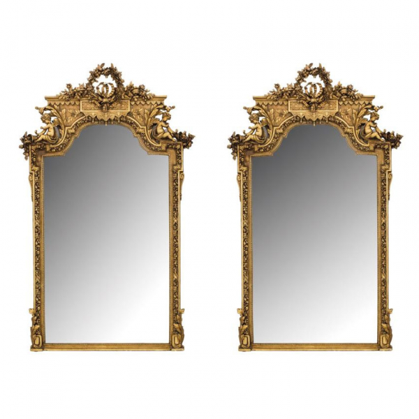 Pareja de espejos monumentales neocl&aacute;sicos circa 1900.  En madera tallada, estucada y dorada.