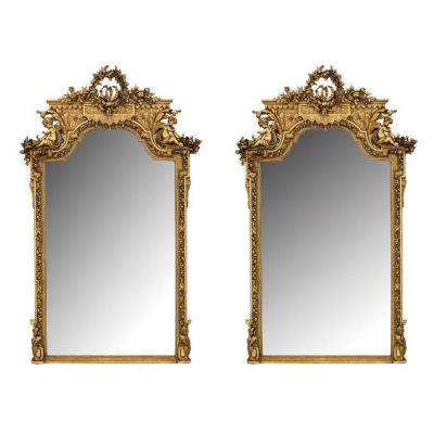 Pareja de espejos monumentales neocl&aacute;sicos circa 1900.  En madera tallada, estucada y dorada.