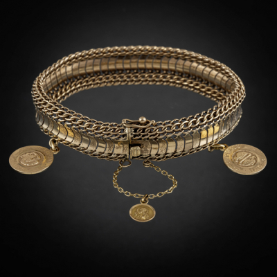 Pulsera articulada con dos medallas del signo del zodiaco en oro amarillo de 18 kt.