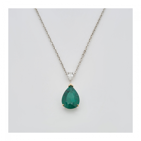 Gargantilla en oro blanco con diamante y esmeralda talla perilla.